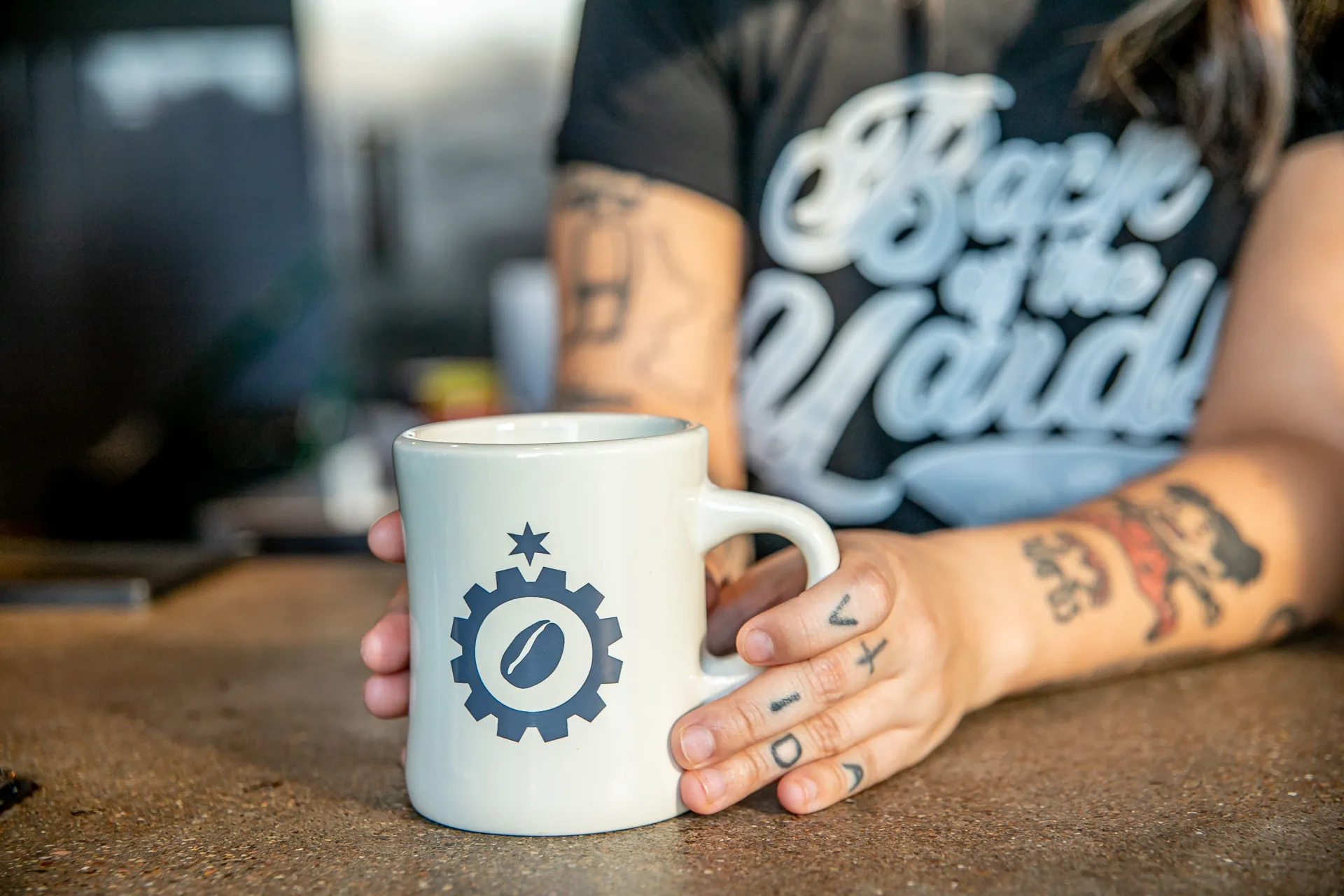 Back of the Yards mug with the star-and-gear logo on the counter